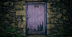 Purple door in stone wall